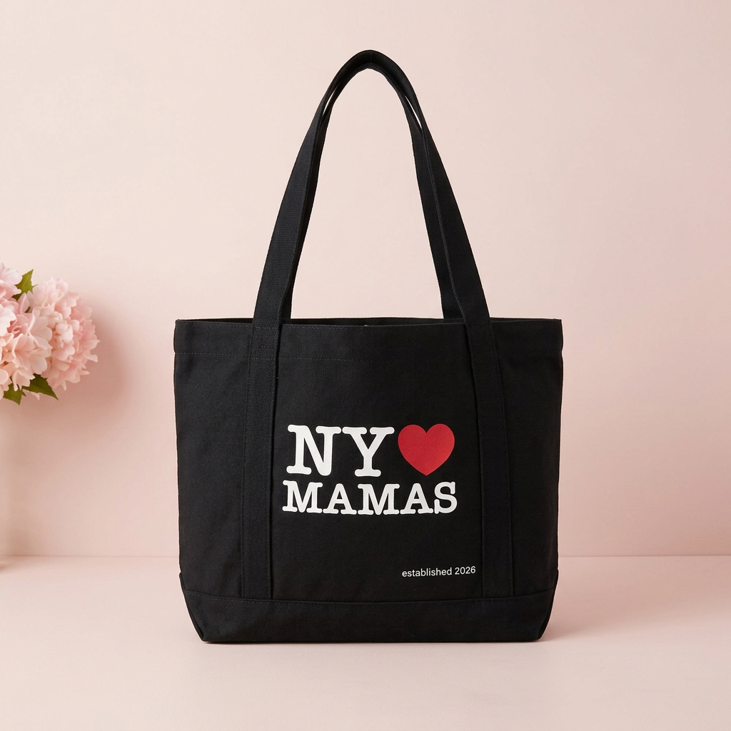 Black NY ♥ MAMAS tote in a soft pink setting with pink flowers